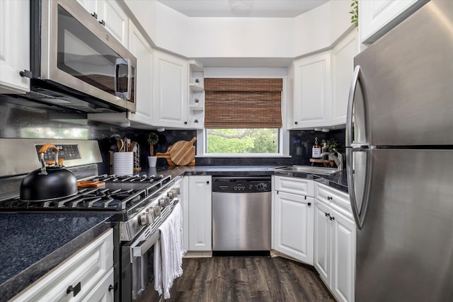 261 Central Ave Unit E4, Lawrence, NY 11559 - kitchen with stainless steel appliances, dark countertops, white cabinetry, and a sink
