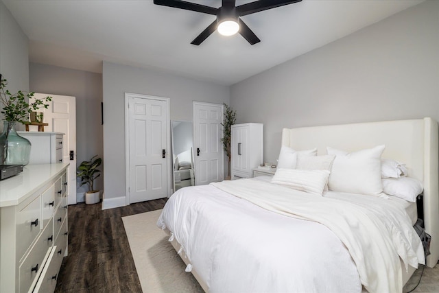 261 Central Ave Unit E4, Lawrence, NY 11559 - bedroom with baseboards, a ceiling fan, dark wood-style flooring, and two closets