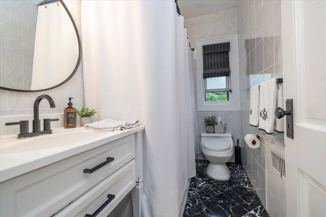 261 Central Ave Unit E4, Lawrence, NY 11559 - bathroom featuring toilet, tile walls, marble finish floor, and vanity