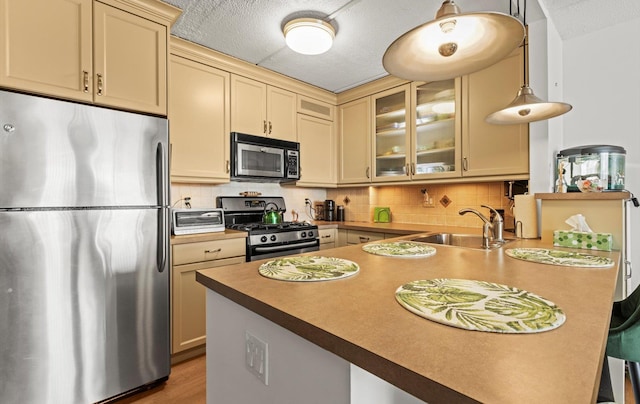 135 Post Ave Unit 5N, Westbury, NY 11590 - kitchen featuring a sink, a toaster, a peninsula, glass insert cabinets, and stainless steel appliances