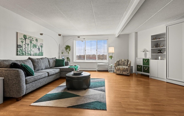 135 Post Ave Unit 5N, Westbury, NY 11590 - living area with a baseboard radiator, a textured ceiling, wood finished floors, and baseboard heating