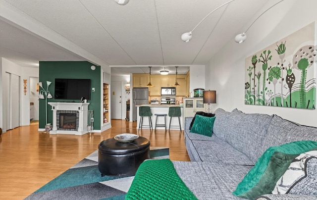 135 Post Ave Unit 5N, Westbury, NY 11590 - living area featuring light wood finished floors and a fireplace