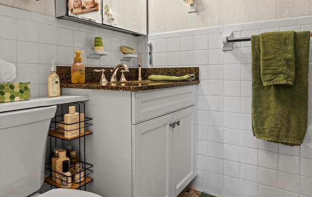135 Post Ave Unit 5N, Westbury, NY 11590 - half bathroom featuring tile walls, vanity, and toilet
