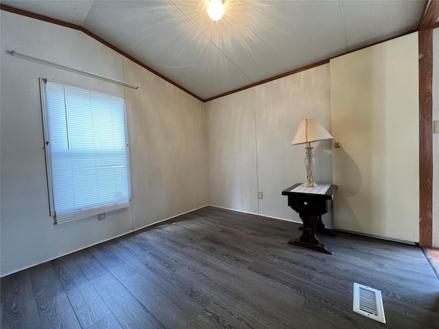 unfurnished room featuring ornamental molding, lofted ceiling, visible vents, and wood finished floors