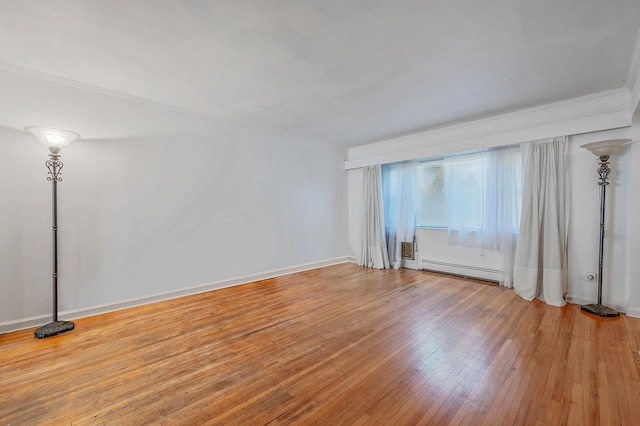 unfurnished room with light wood-style floors, ornamental molding, baseboards, and baseboard heating