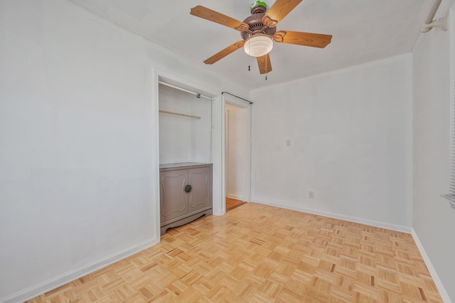 unfurnished bedroom featuring a ceiling fan and baseboards