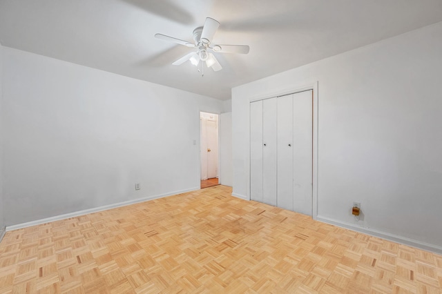 unfurnished bedroom featuring baseboards, ceiling fan, and a closet