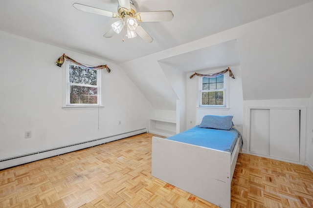bedroom with a baseboard radiator, ceiling fan, and lofted ceiling