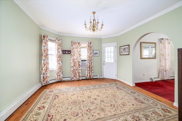 interior space with crown molding, arched walkways, a chandelier, wood finished floors, and a baseboard radiator