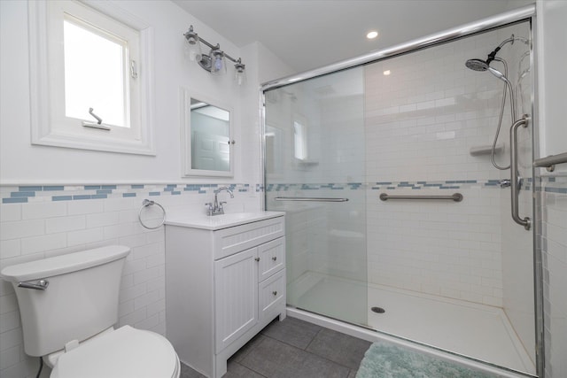 full bath featuring tile walls, tile patterned flooring, a stall shower, vanity, and toilet