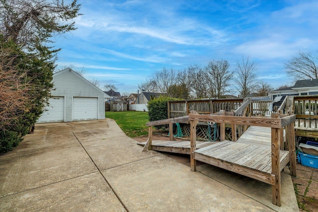 exterior space featuring a detached garage, a yard, and an outbuilding