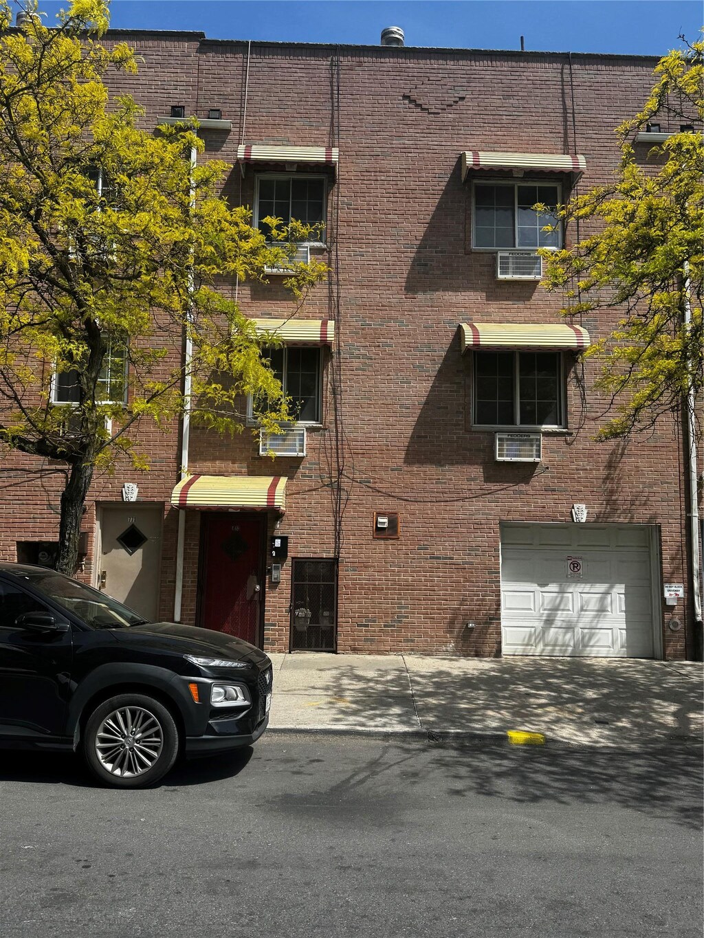 view of building exterior featuring an attached garage and driveway