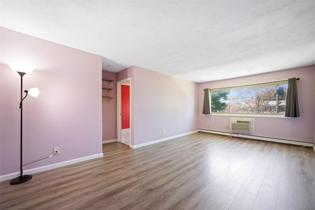 2433 Union Blvd Unit 4B, Islip, NY 11751 - unfurnished living room featuring baseboards, a baseboard radiator, a wall unit AC, and wood finished floors