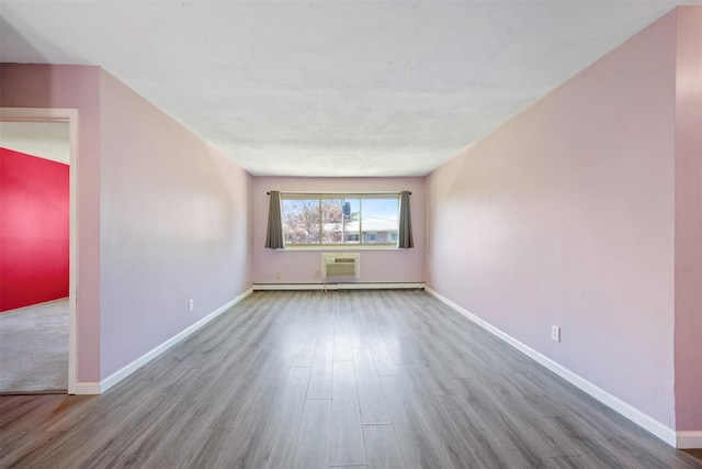 2433 Union Blvd Unit 4B, Islip, NY 11751 - empty room with wood finished floors, baseboards, a wall mounted AC, and baseboard heating