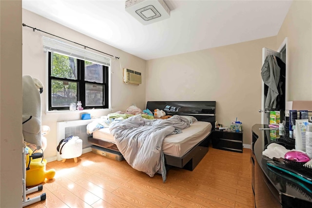 58-37 246th Cres Unit 1F, Little Neck, NY 11362 - bedroom with a wall unit AC and light wood-style floors