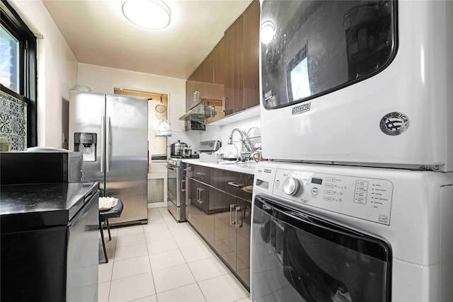 58-37 246th Cres Unit 1F, Little Neck, NY 11362 - washroom with stacked washing maching and dryer and light tile patterned flooring