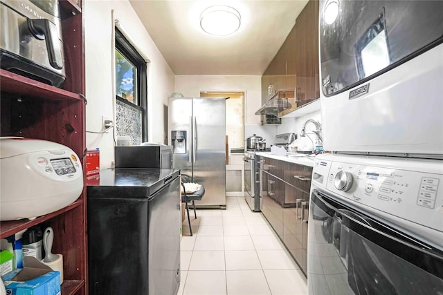 58-37 246th Cres Unit 1F, Little Neck, NY 11362 - washroom featuring stacked washer / drying machine, light tile patterned floors, and laundry area