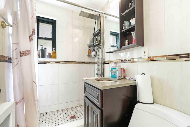 58-37 246th Cres Unit 1F, Little Neck, NY 11362 - bathroom with toilet, tile walls, a tile shower, and vanity