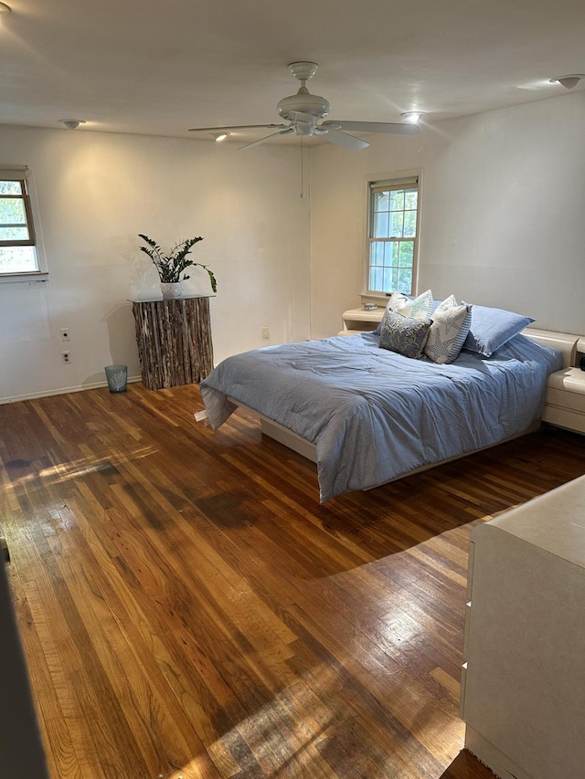 bedroom featuring a ceiling fan and wood finished floors