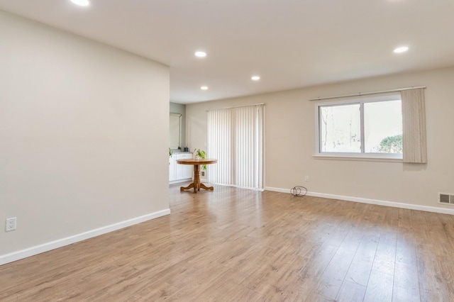 unfurnished room featuring baseboards and recessed lighting