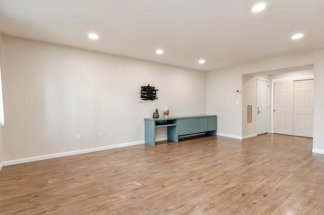 unfurnished room with baseboards, recessed lighting, light wood-style flooring, and visible vents