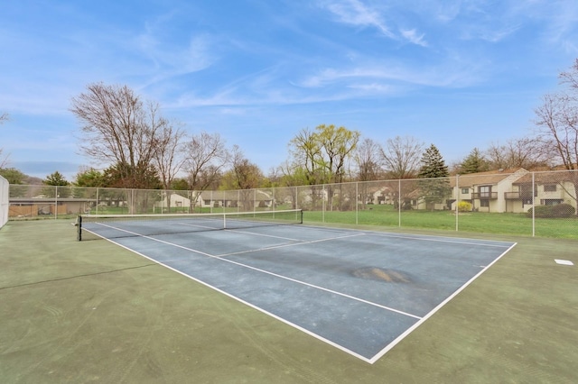 view of sport court featuring fence and a residential view
