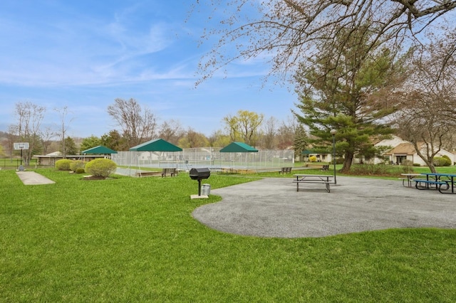 surrounding community featuring a lawn and fence