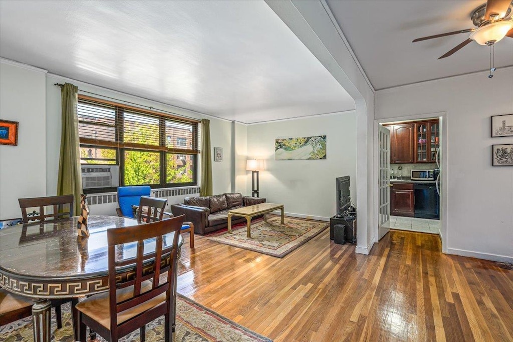 67-35 Yellowstone Blvd Unit 5P, Forest Hills, NY 11375 - dining area with ceiling fan, baseboards, cooling unit, radiator, and hardwood / wood-style floors