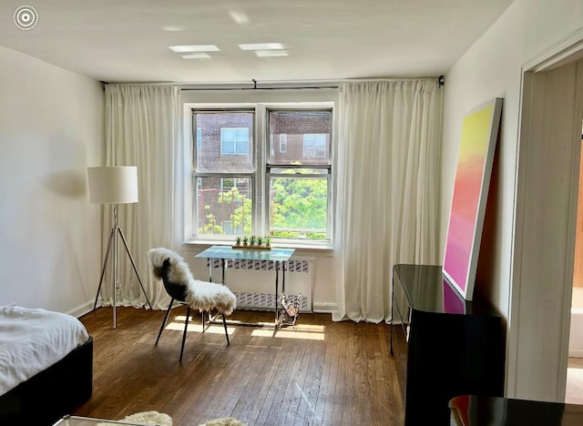 67-14 108th St Unit 6C, Forest Hills, NY 11375 - living area featuring radiator heating unit and hardwood / wood-style flooring