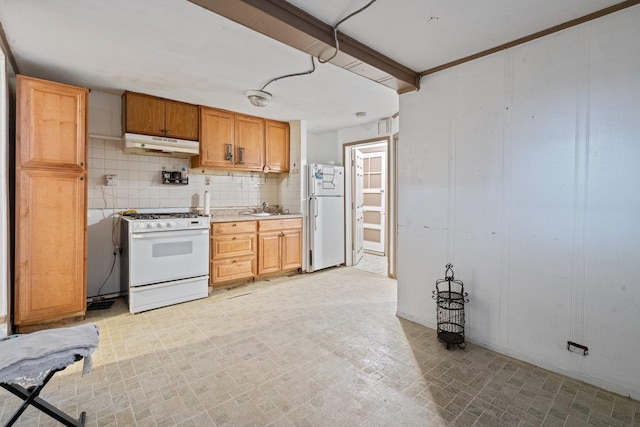 kitchen featuring a sink, white appliances, light countertops, decorative backsplash, and under cabinet range hood