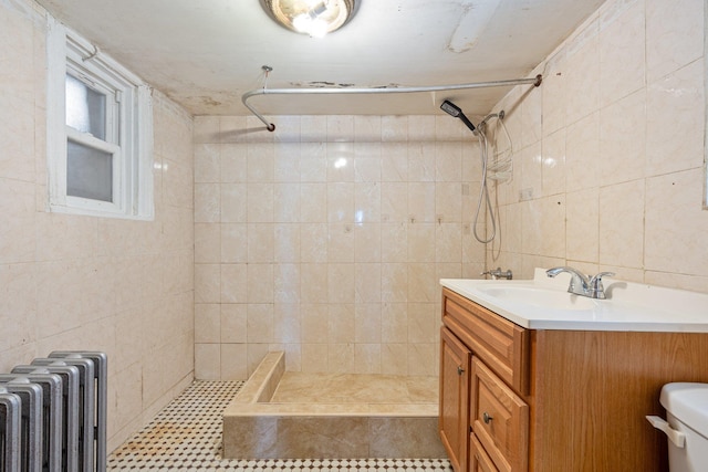full bath featuring radiator heating unit, tile walls, a stall shower, and toilet