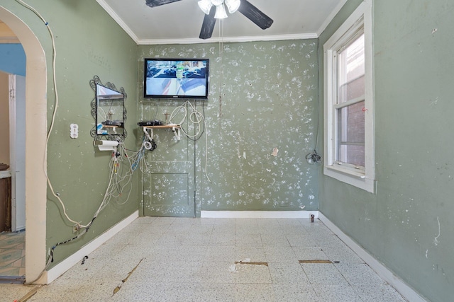 bathroom with a ceiling fan, baseboards, and ornamental molding