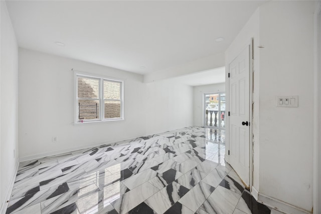 unfurnished room featuring baseboards