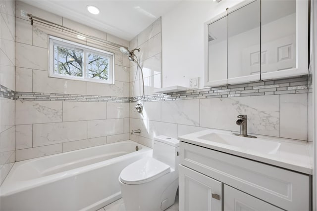 bathroom featuring toilet, tile walls, bathing tub / shower combination, and vanity