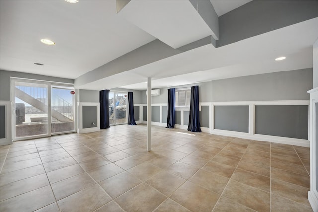 tiled empty room featuring baseboards, recessed lighting, and a wall mounted air conditioner