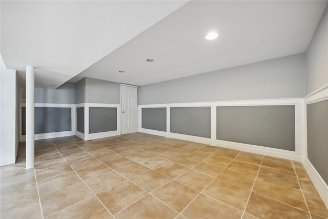 finished below grade area featuring recessed lighting and light tile patterned flooring