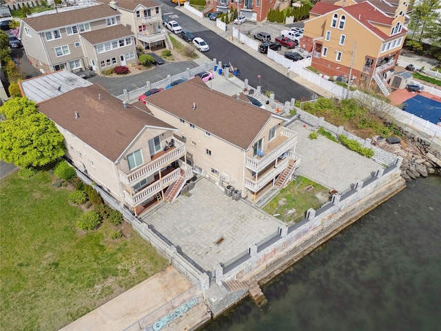drone / aerial view with a residential view and a water view