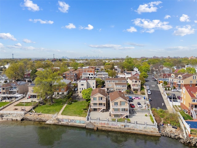 drone / aerial view featuring a water view and a residential view