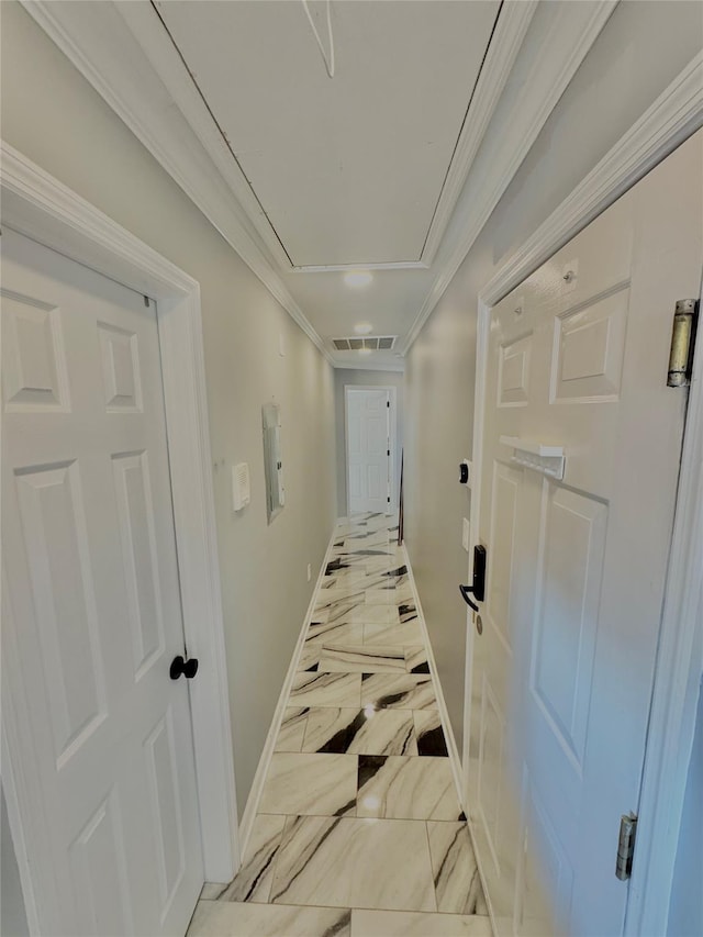 corridor featuring crown molding, visible vents, marble finish floor, baseboards, and attic access