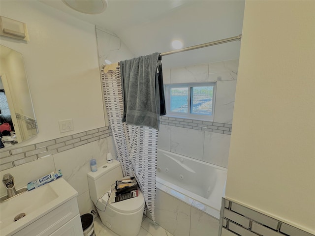 full bath with vanity, toilet, shower / tub combo, and tile walls