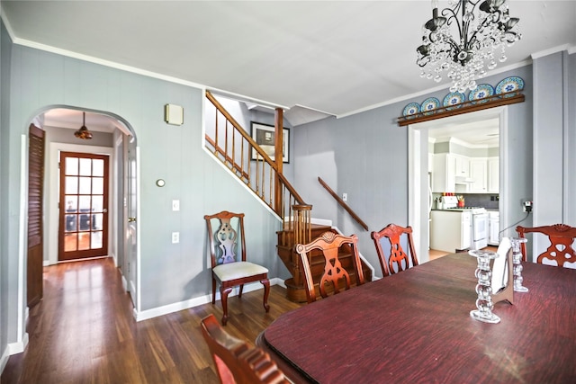 8 Rose Ct, Northport, NY 11768 - dining space with crown molding, stairs, dark wood-type flooring, arched walkways, and a notable chandelier