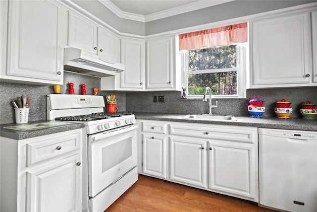 8 Rose Ct, Northport, NY 11768 - kitchen featuring crown molding, dark countertops, white appliances, under cabinet range hood, and a sink