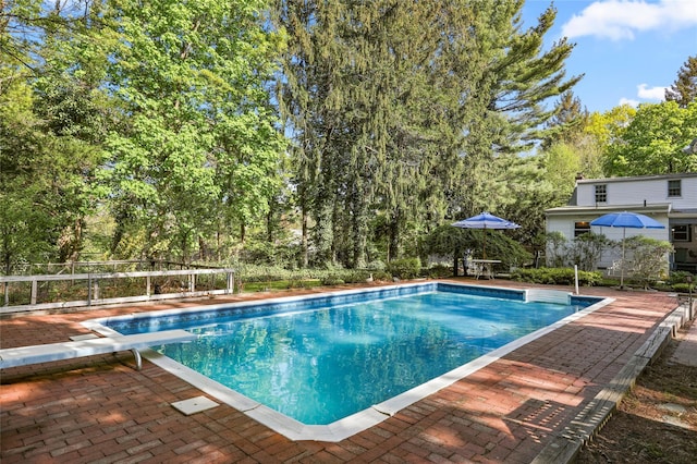 8 Rose Ct, Northport, NY 11768 - view of swimming pool with a fenced in pool, a diving board, and a patio area
