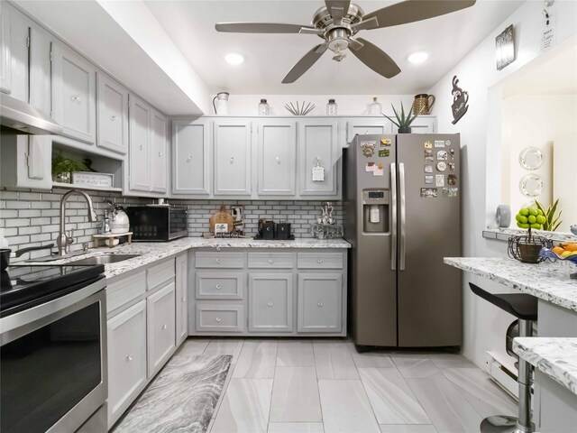 81-56 102nd Rd, Ozone Park, NY 11416 - kitchen with stainless steel appliances, ceiling fan, decorative backsplash, and a sink