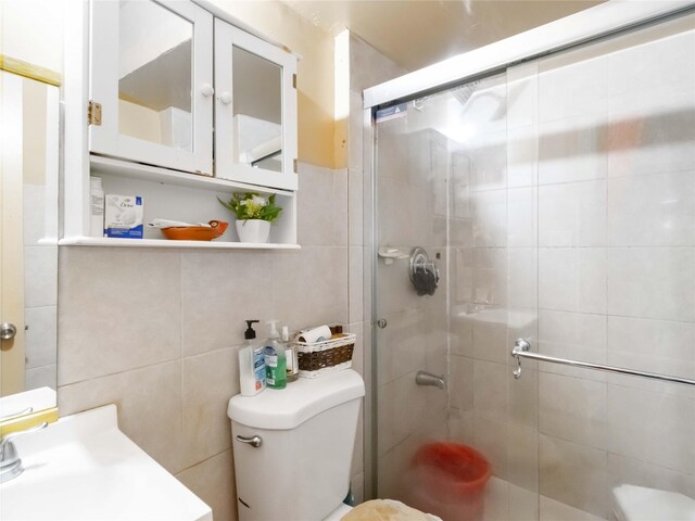 81-56 102nd Rd, Ozone Park, NY 11416 - full bathroom featuring toilet, tile walls, and a stall shower