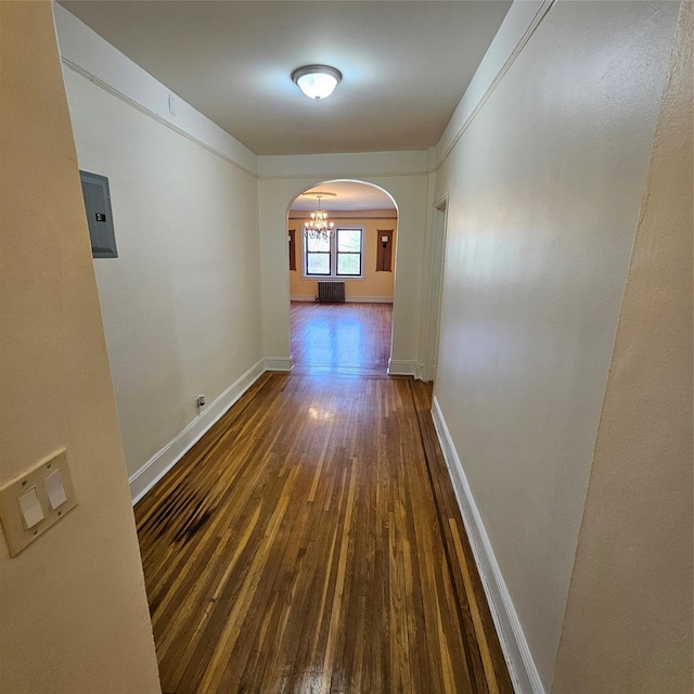 590 E 3rd St Unit 2-O, Mount Vernon, NY 10553 - corridor featuring electric panel, arched walkways, baseboards, dark wood-style floors, and radiator heating unit