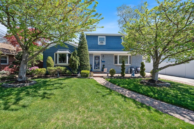 view of front of home with fence and a front yard