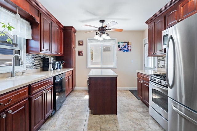 kitchen with stainless steel appliances, ceiling fan, a sink, and tasteful backsplash
