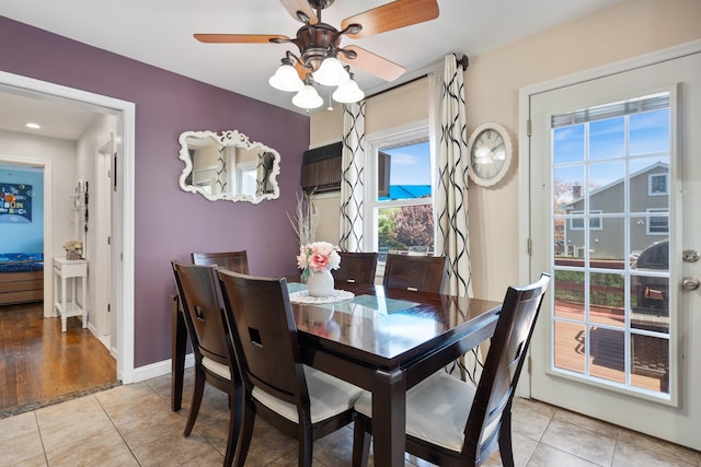 dining area with baseboards, a ceiling fan, and light tile patterned flooring