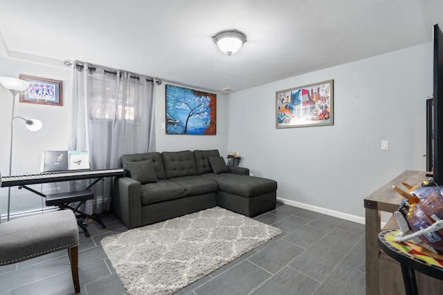 living area featuring baseboards